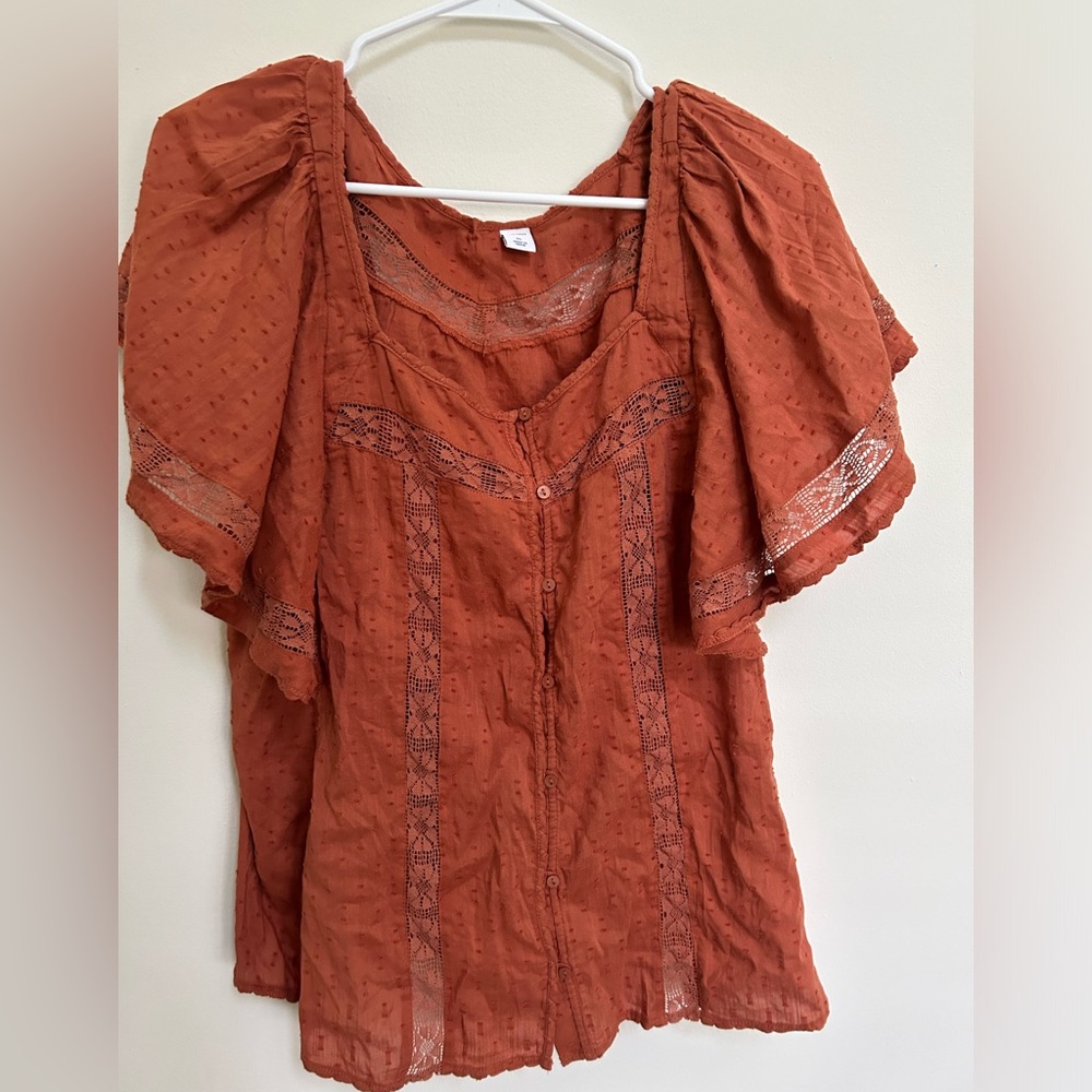 Terra cotta colored button front cotton blouse with delicate trim detail